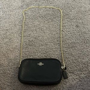 Small black Coach satchel bag with removable gold chain strap.